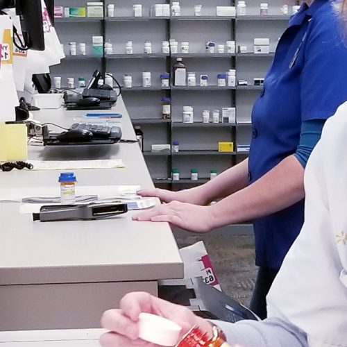 healthcare-and-medicine-a-pharmacy-technician-prepares-a-prescription-order-while-the-pharmacist_t20_OzYYvL
